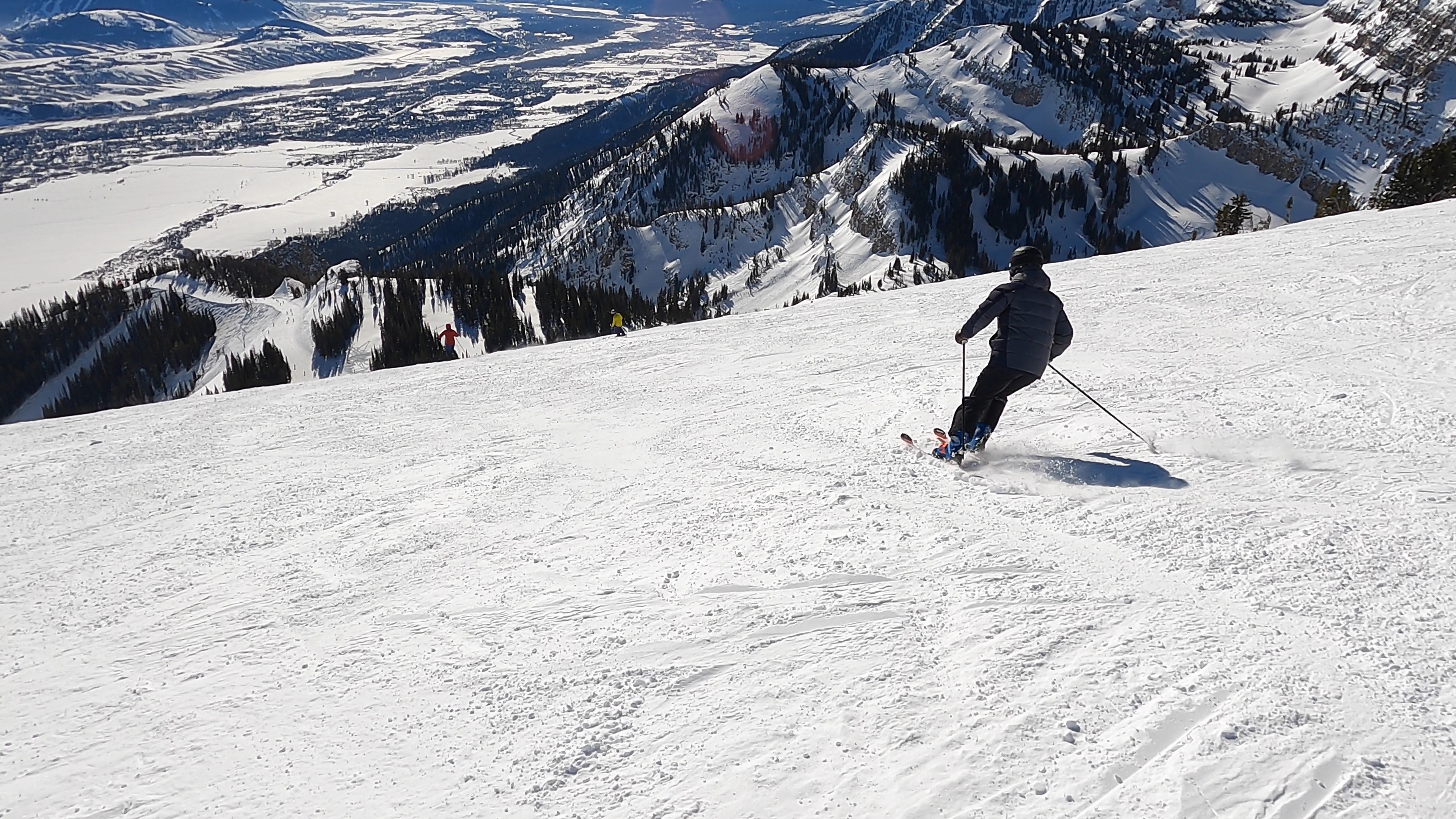 Chairlift and skier on a scenic ridge in North America